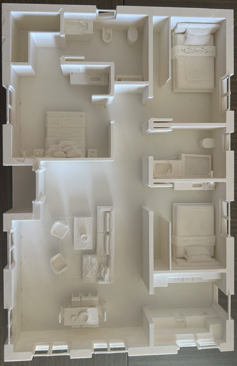 Maqueta impresa en 3D de la distribución de una vivienda, vista cenital
